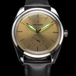 Runde Gold — lume glow on gold dial