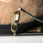 AV86 1954 Capri Green/Gold — case profile with the synthetic sapphire cabochon crown