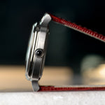 Smiths x AV86 Raqeeqa — case profile with the crown cabochon and burgundy lizard-grain leather strap